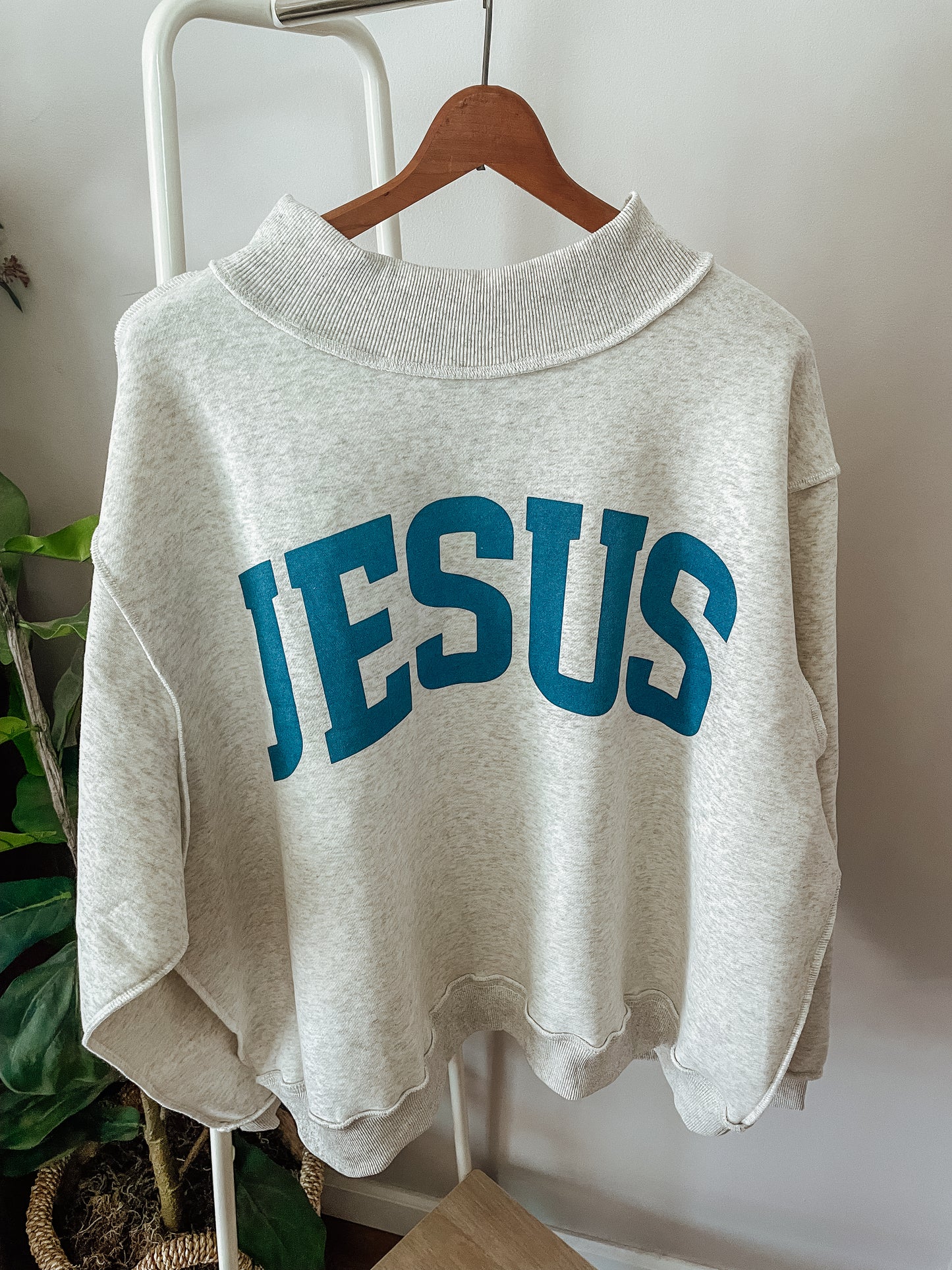 ‘Jesus & God is good’ reversible mockneck sweater