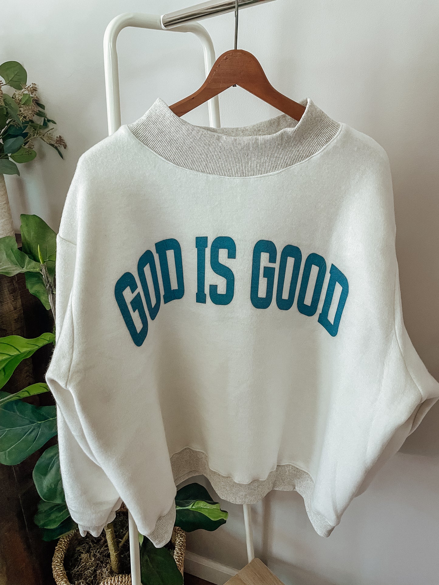 ‘Jesus & God is good’ reversible mockneck sweater